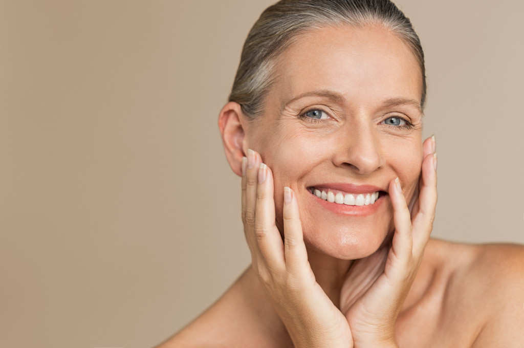 Closeup face of happy senior woman feeling fresh after anti-aging treatment.